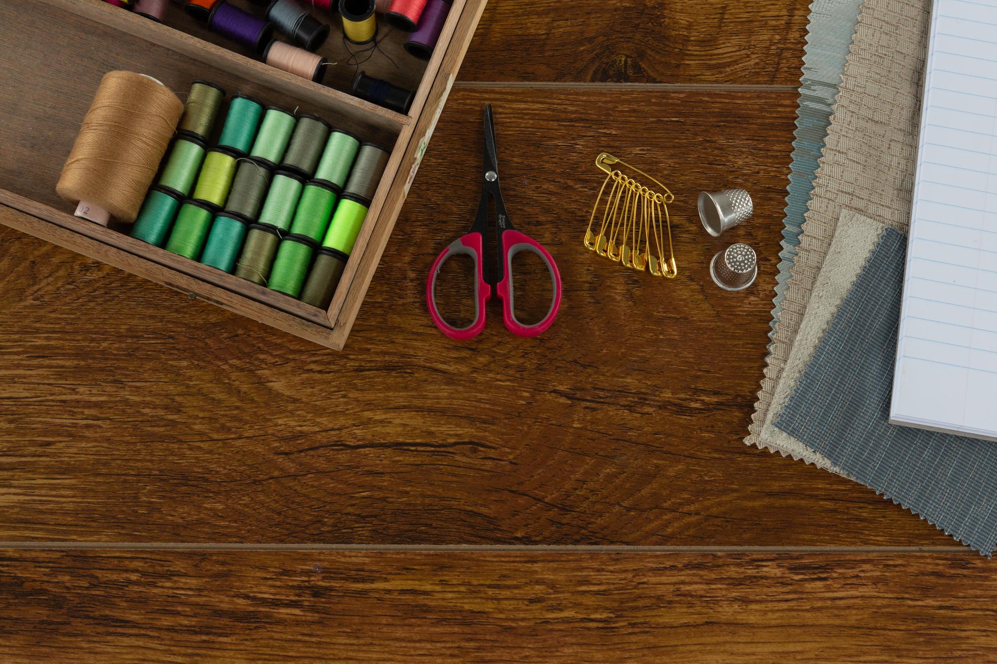 Flatlay of embroidery tools and threads
